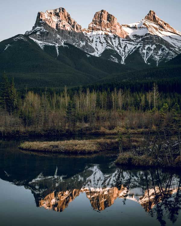 The Three Sisters Reflected On Water near Canmore