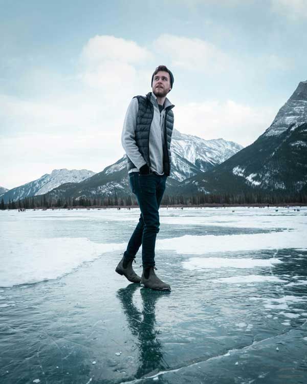 Man On Ice With Mountains Behind